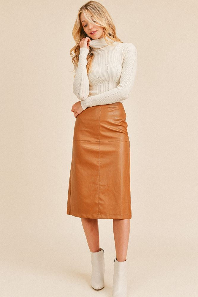 a woman wearing leather skirt in camel color