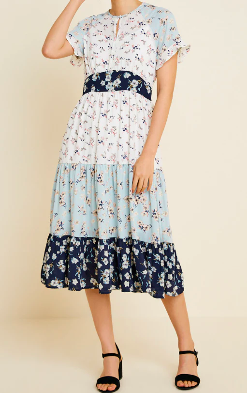 A multi-tiered dress with various prints styled together.